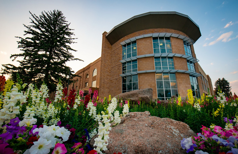 Exterior of Half Acre Gym with flowers planted