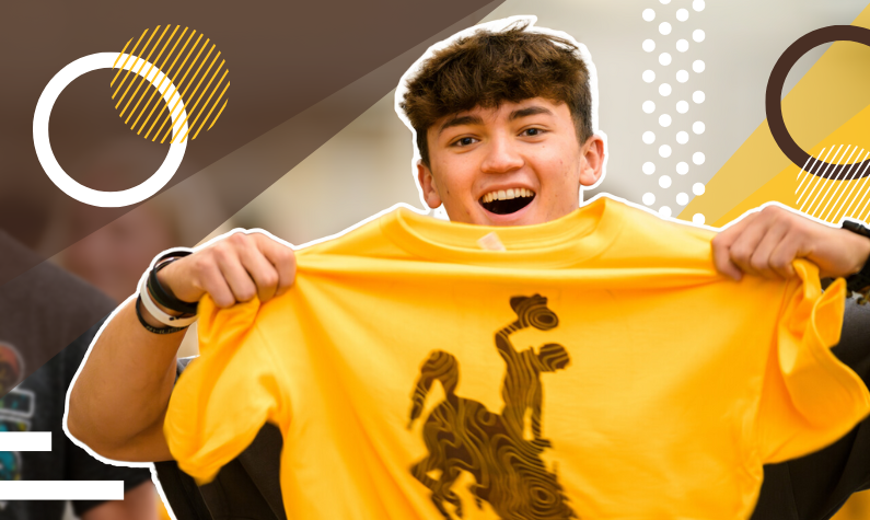 Student holds up new t-shirt given out at Saddle Up events