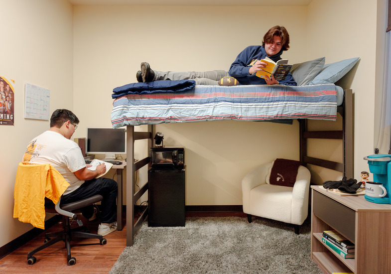 two roommates study in their dorm room 