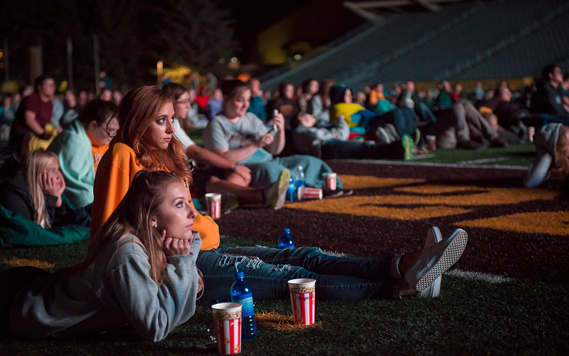 UW students enjoying movie in War Memorial stadium