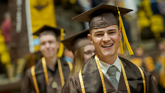 Some College student smiling at graduation