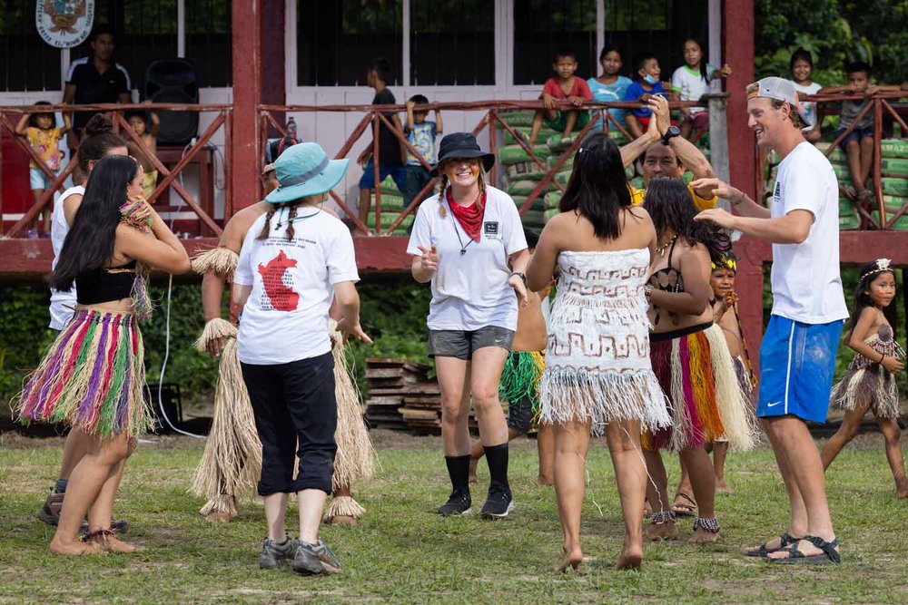 Students dancing with people in Peru 