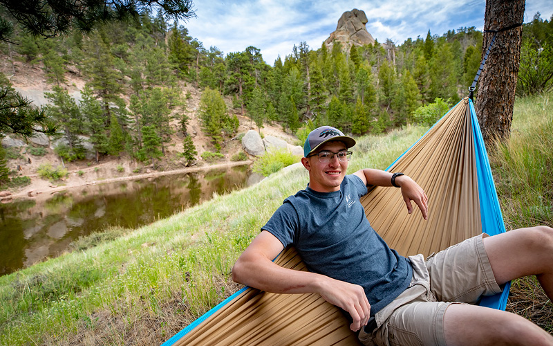 Student enjoying the outdoors in a hammock