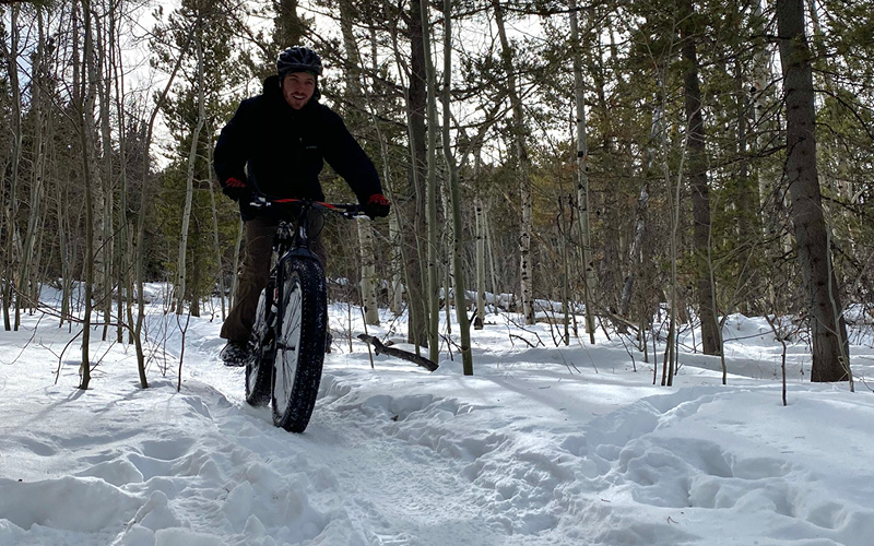 Male biking in snow