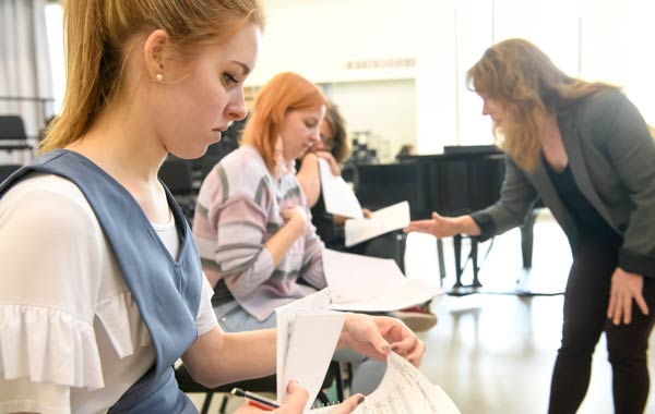 Music students looking at sheet music during class