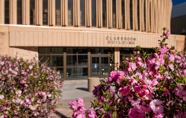 Outside of the classroom building with flowers