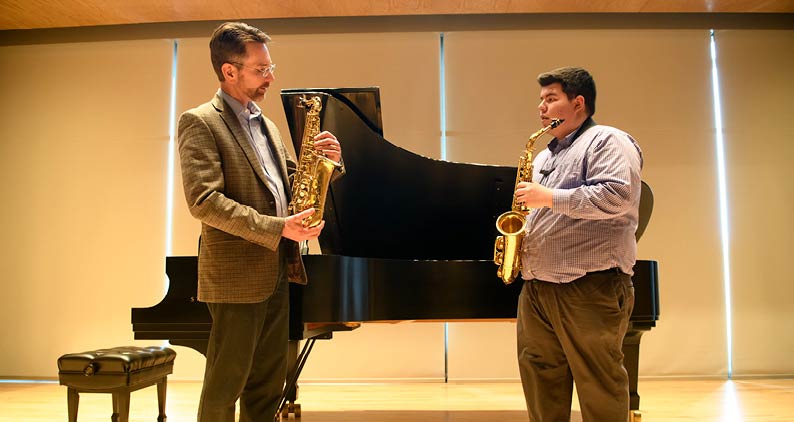 Professor and student play saxophone together