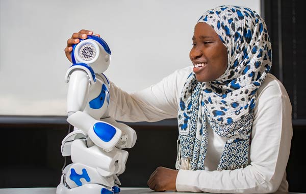 Female student with miniature robot