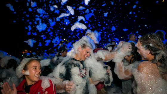 Students having a foam party outside of the dorms