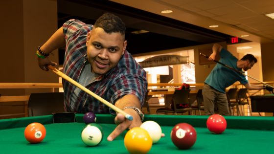 Student playing pool in the basement of the Union