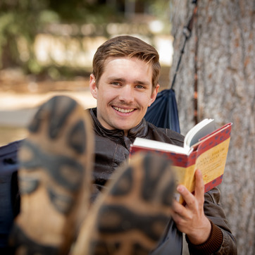 student reading in a hammock
