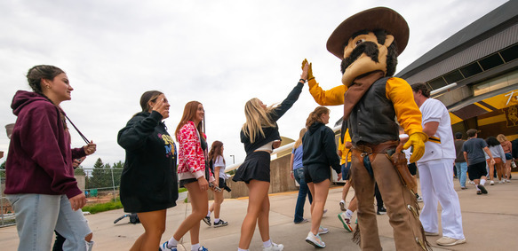 pistol pete high fiving students