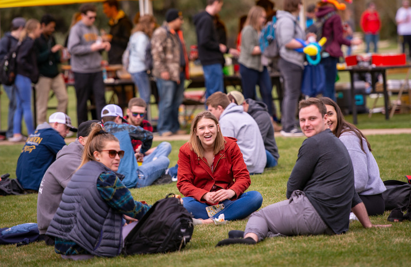 a group of students sit in a circle outside