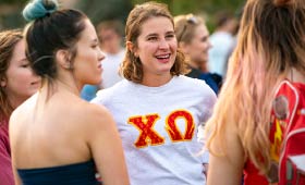 Sorority students stand together during an event.