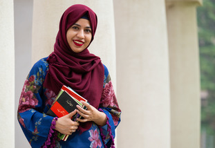 student outside the Cooper House