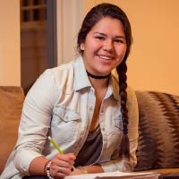 A student studies on a couch.