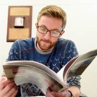 A student reads a magazine.