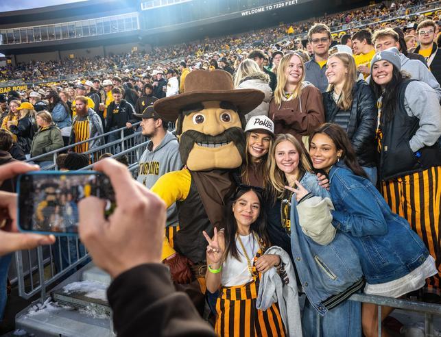 student pose with Pistol Pete for a photo