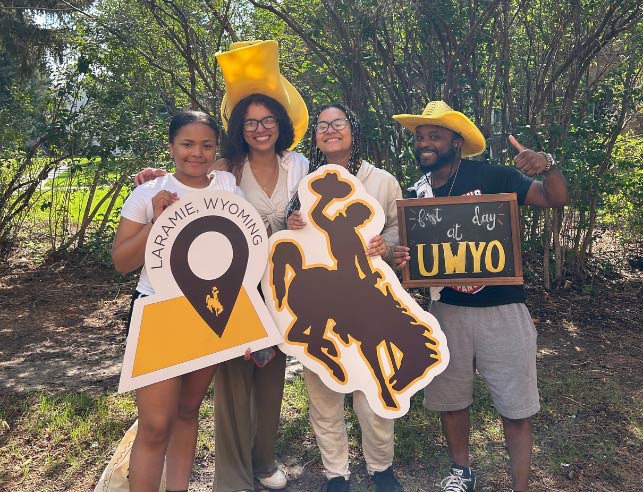 a student and their family with UW gear