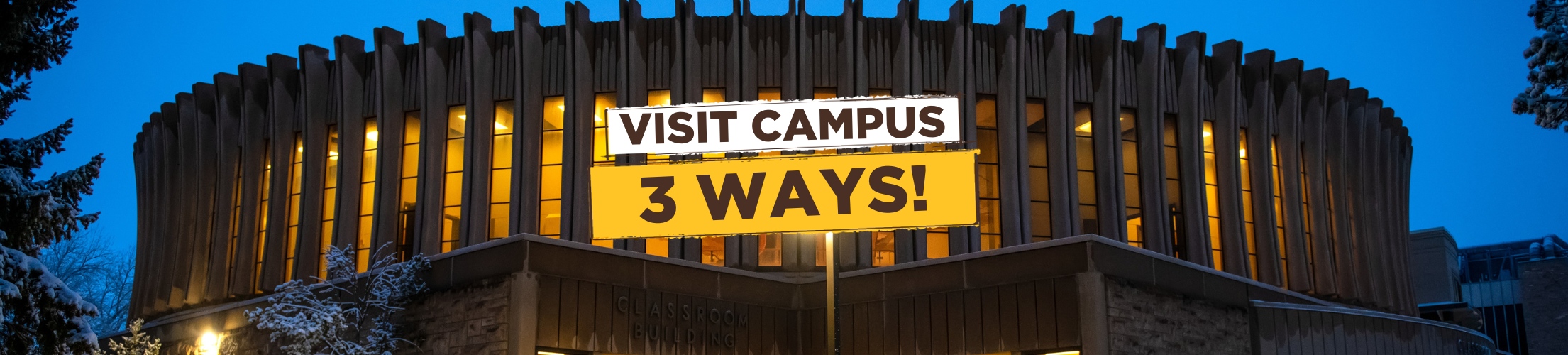 A winter scene of the UW classroom building lit up an night against the sky with the words "Visit Campus 3 Ways" over top in white and yellow boxes.