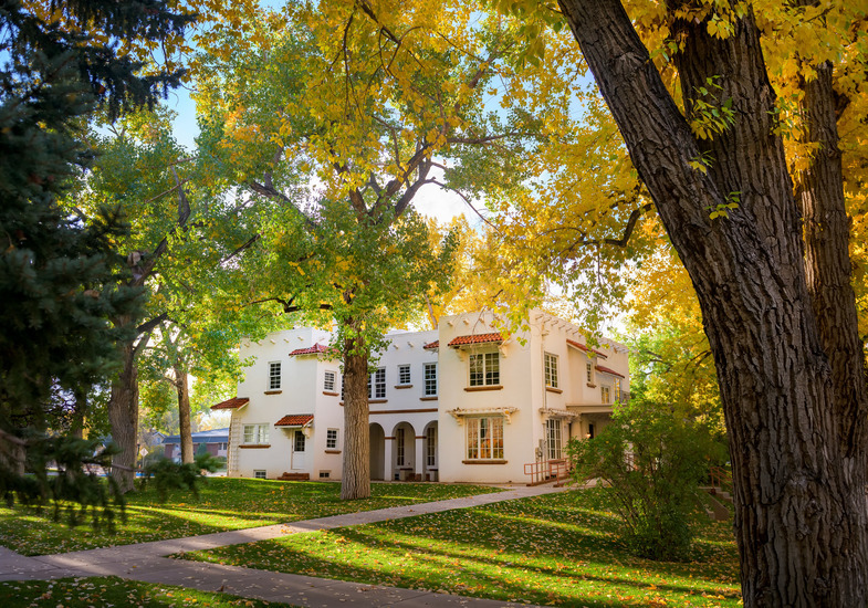 Exterior view of the Cooper House, which has a parking lot located at its side.