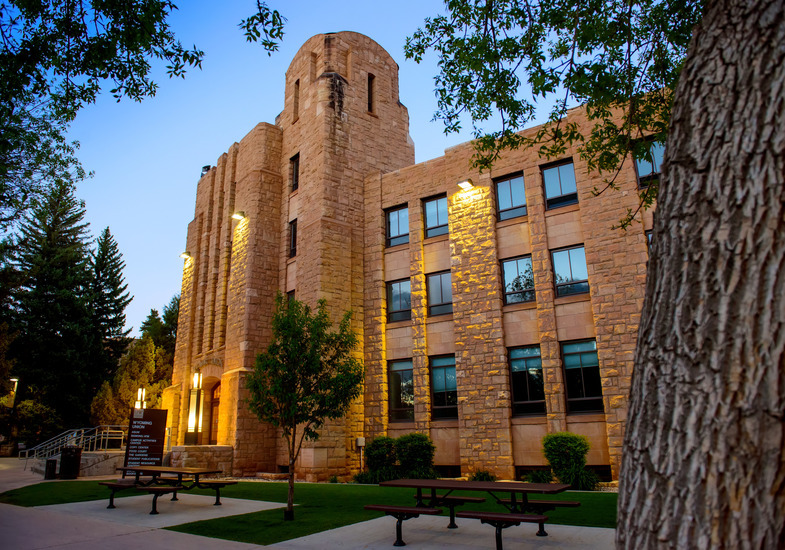 Exterior of the Wyoming Union at dusk with the lights on. 