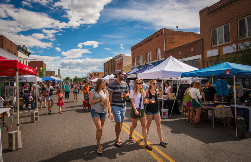 people walk downtown laramie during a farmers market event.