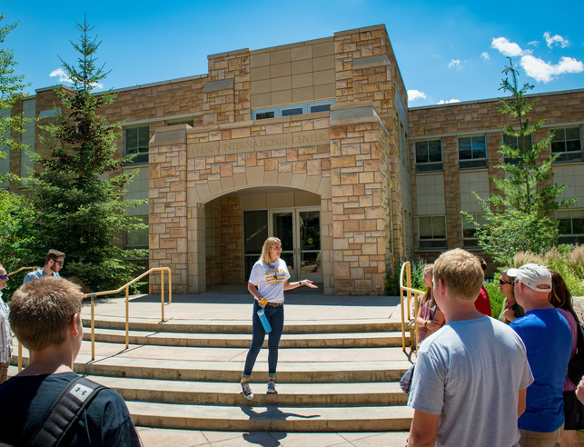 Admissions rep leads a tour across campus