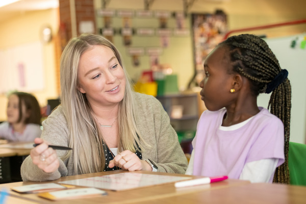 Teacher working with young child