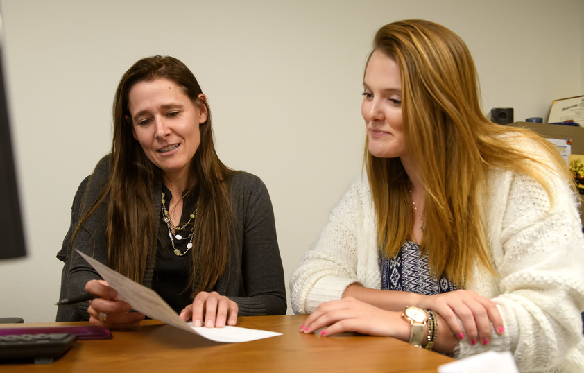 Faculty member and student looking at a paper together