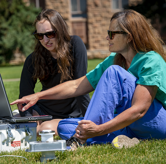 agricultral and applied economics faculty working with a funded graduate assistant on rural health care economics