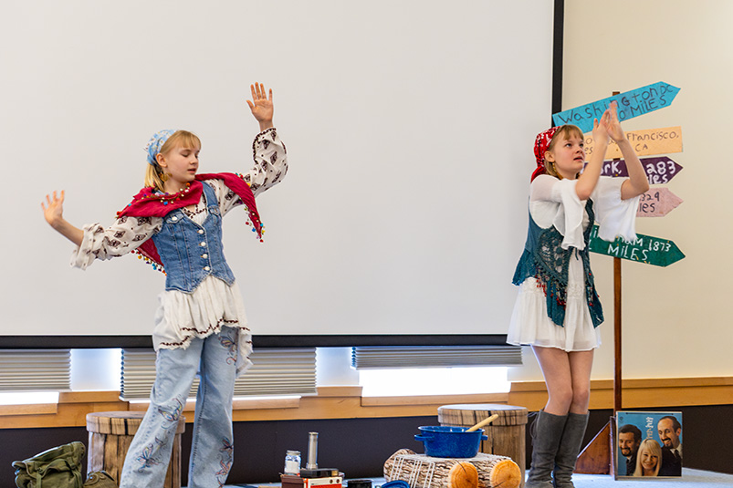 two children performing in front of an audience