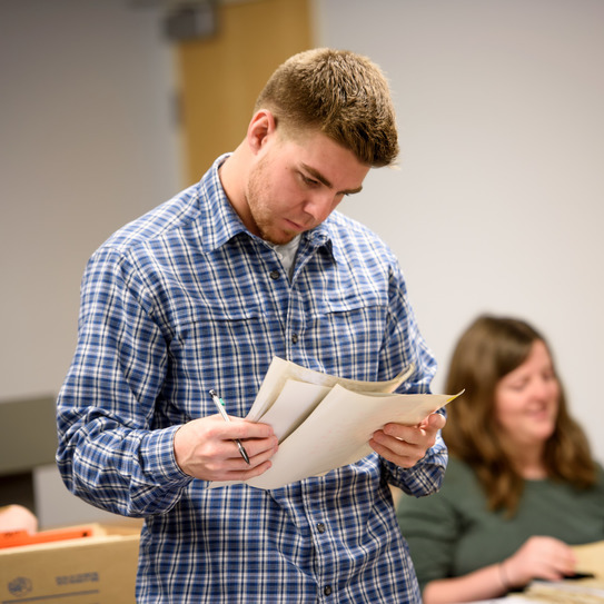 A man reads a historic document
