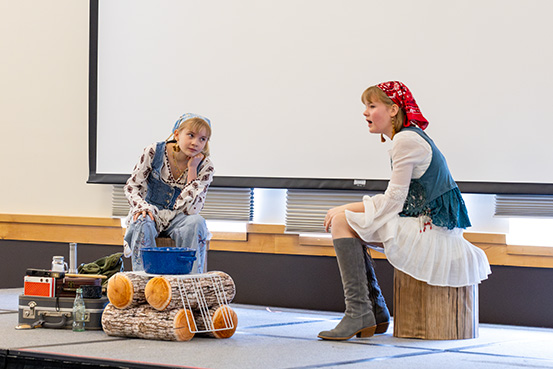 Two girls dressed in bandanas and denim jackets perform for Wyoming History Day