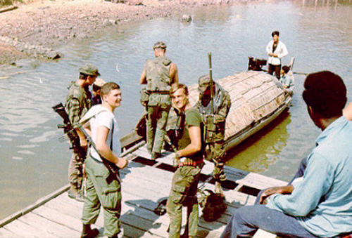 Soldiers by canal, 1968-1969.