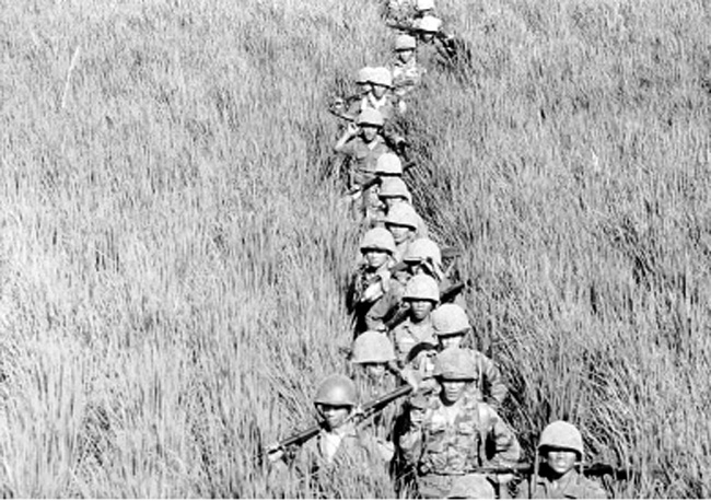 Soldiers on ground patrol in Vietnam, 1962.