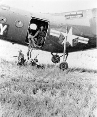 Troops landing from helicopter.