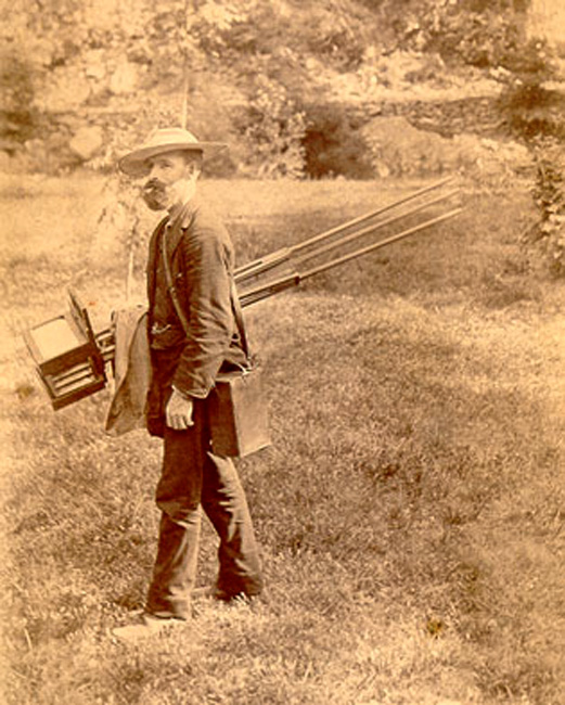 Owen Wister carrying camera, no date.