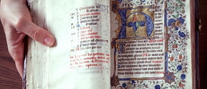 Open book with colorfully inscribed text and graphics. 