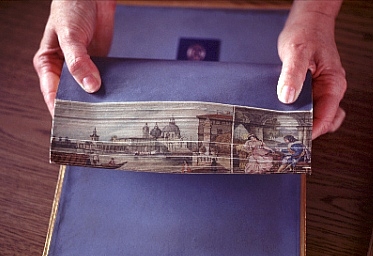 Water color painting on a book edge. The Venice grand canal with the Duomo in the background.