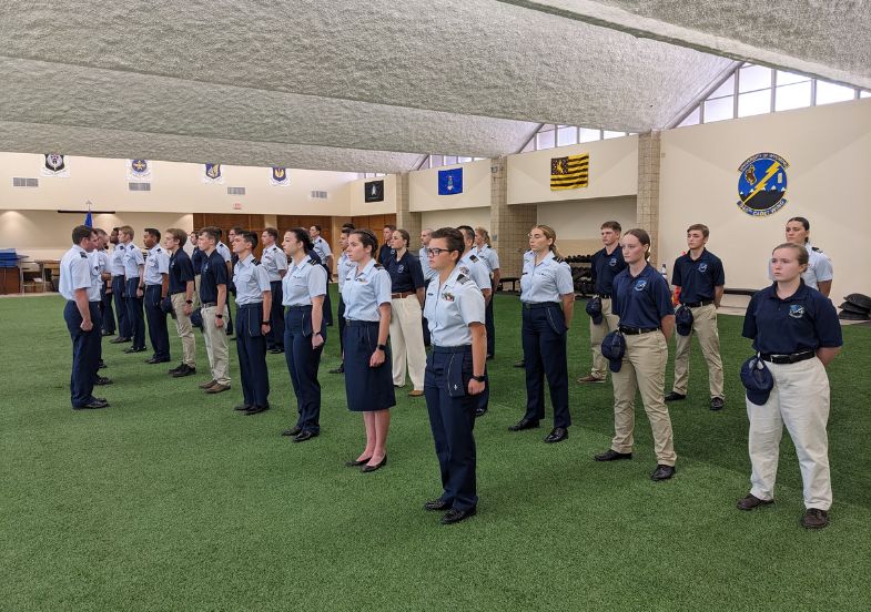 Air Force ROTC cadets stand at attention during a drill.