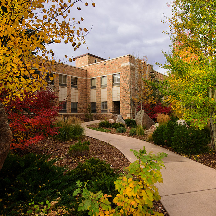 Outside picture of a UW campus building in the fall with autumn leaves