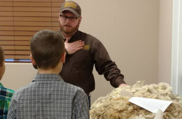 Whit Stewart explaining wool judging principles using a fleece. 