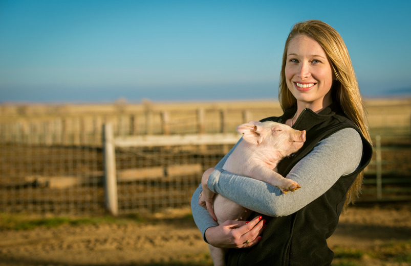 girl holding pig