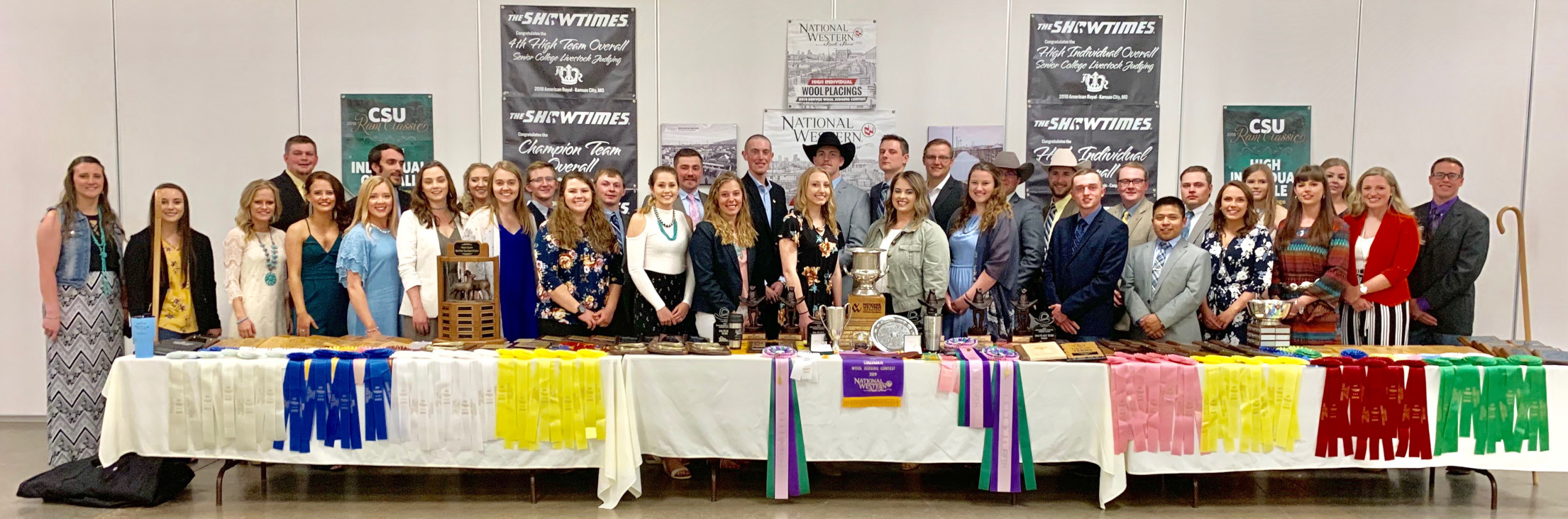 UW Judging team members standing in front of their awards. 