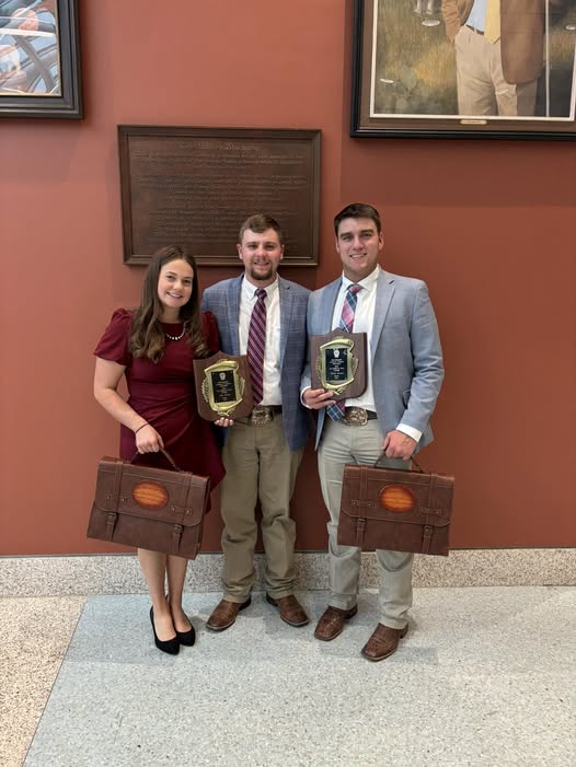 students stand with an American Brahman bovine