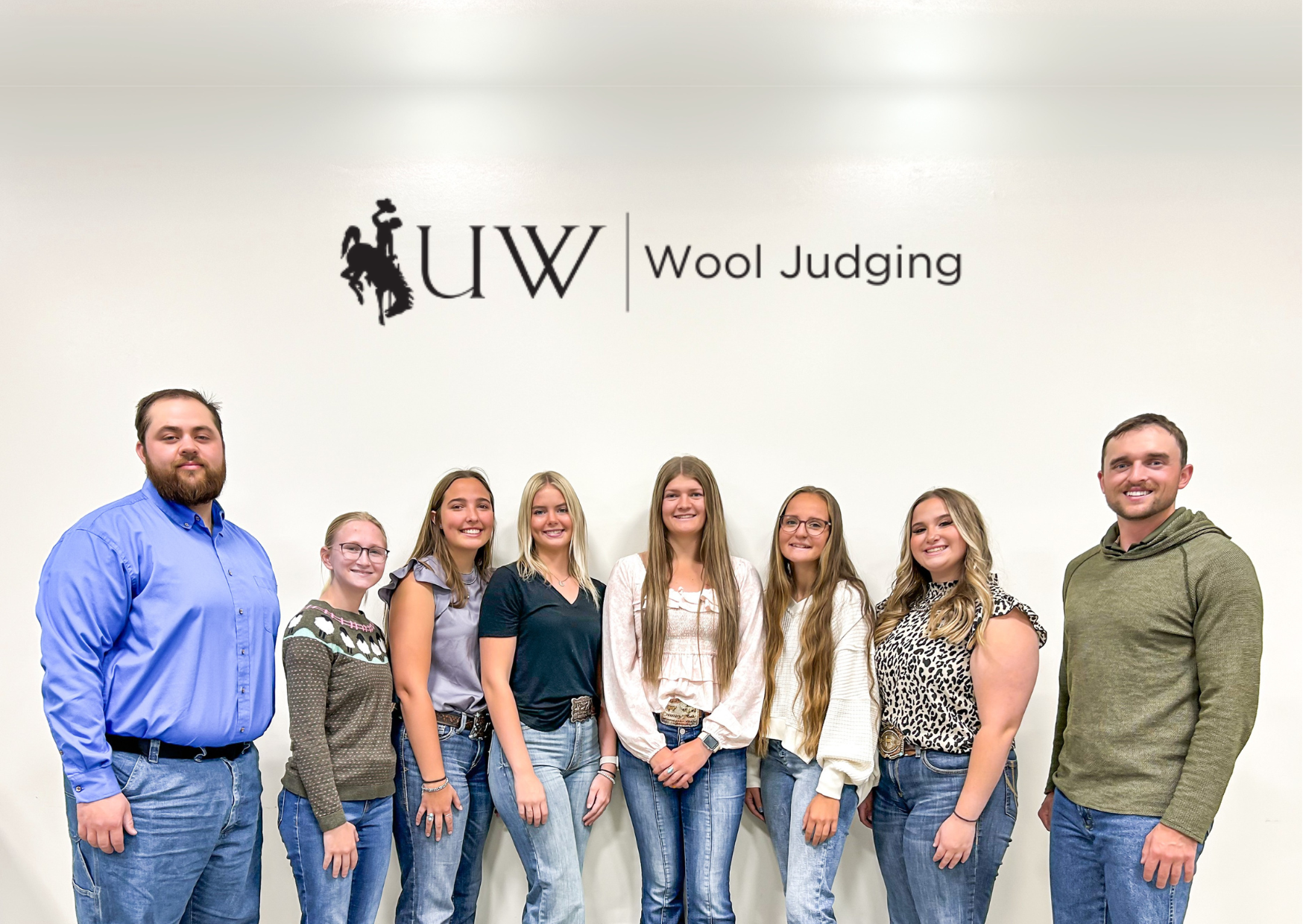 group of people standing in front of a wall
