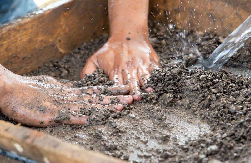 hands in dirt sifter