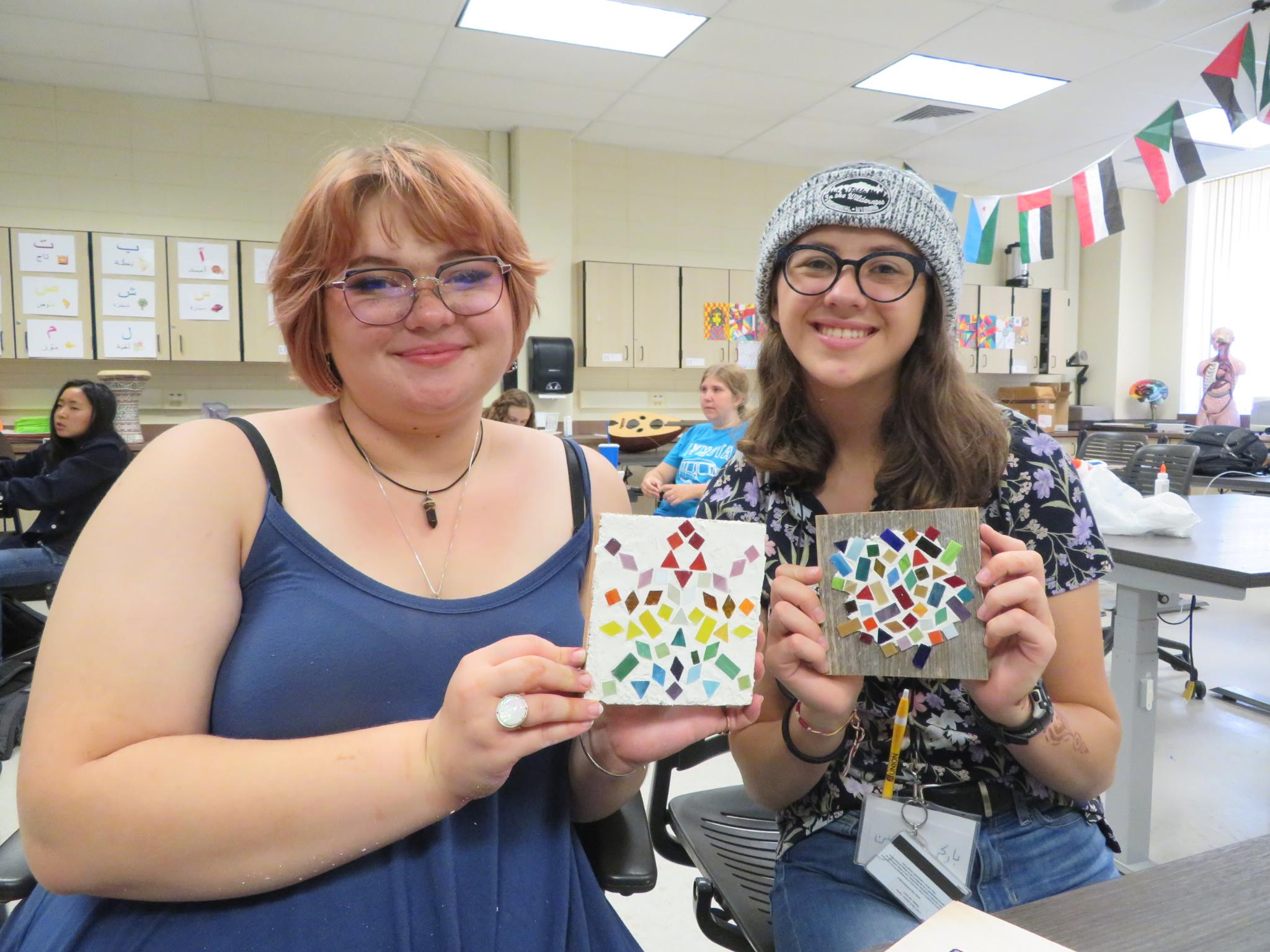two students showing their mosaic art