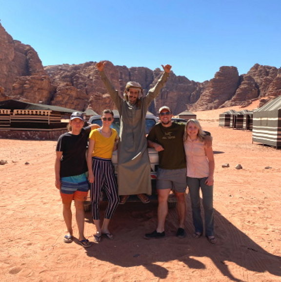 students on a truck in the desert